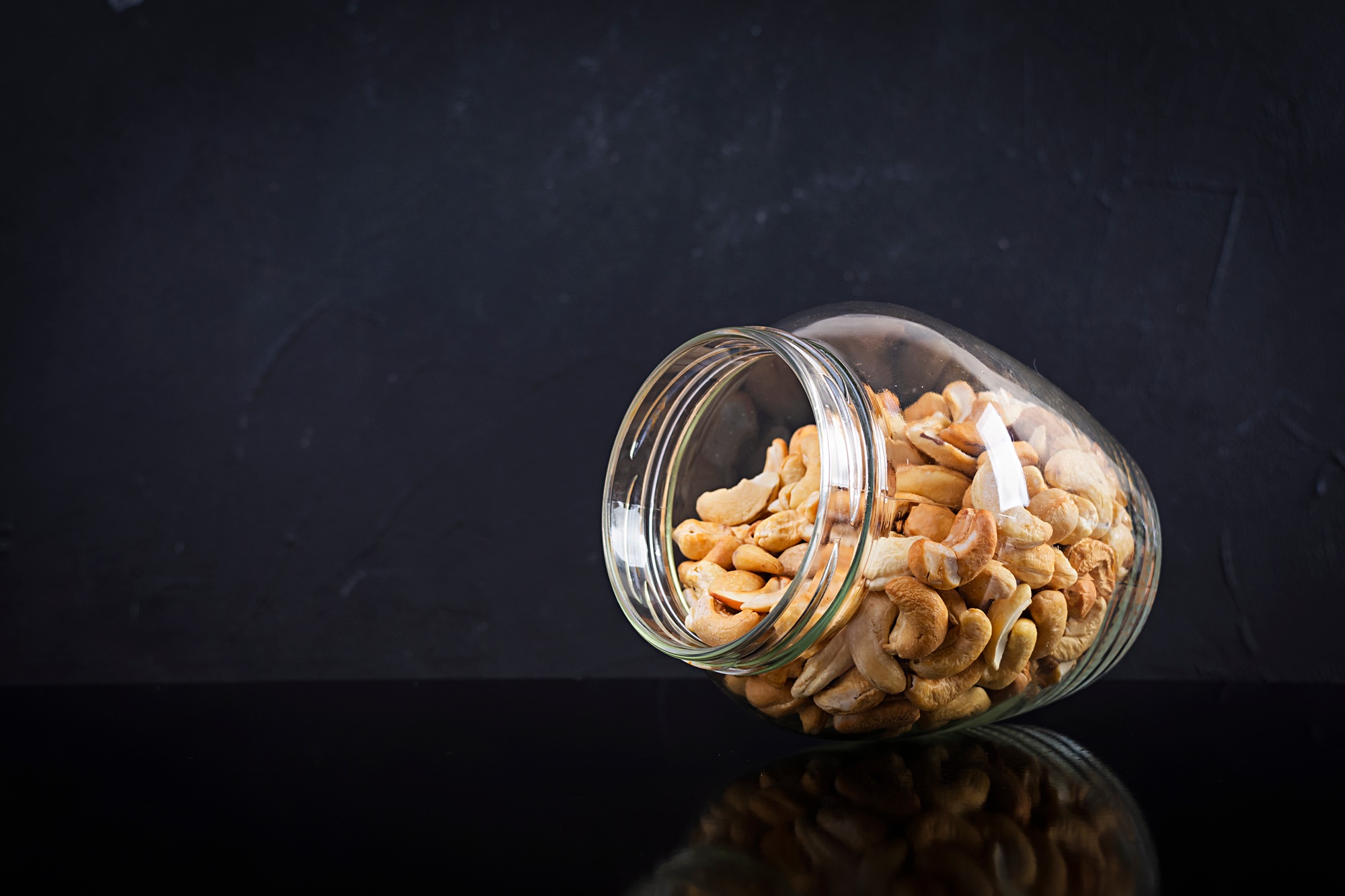Cashew nuts in a jar. Set of cashew nut isolated on dark background