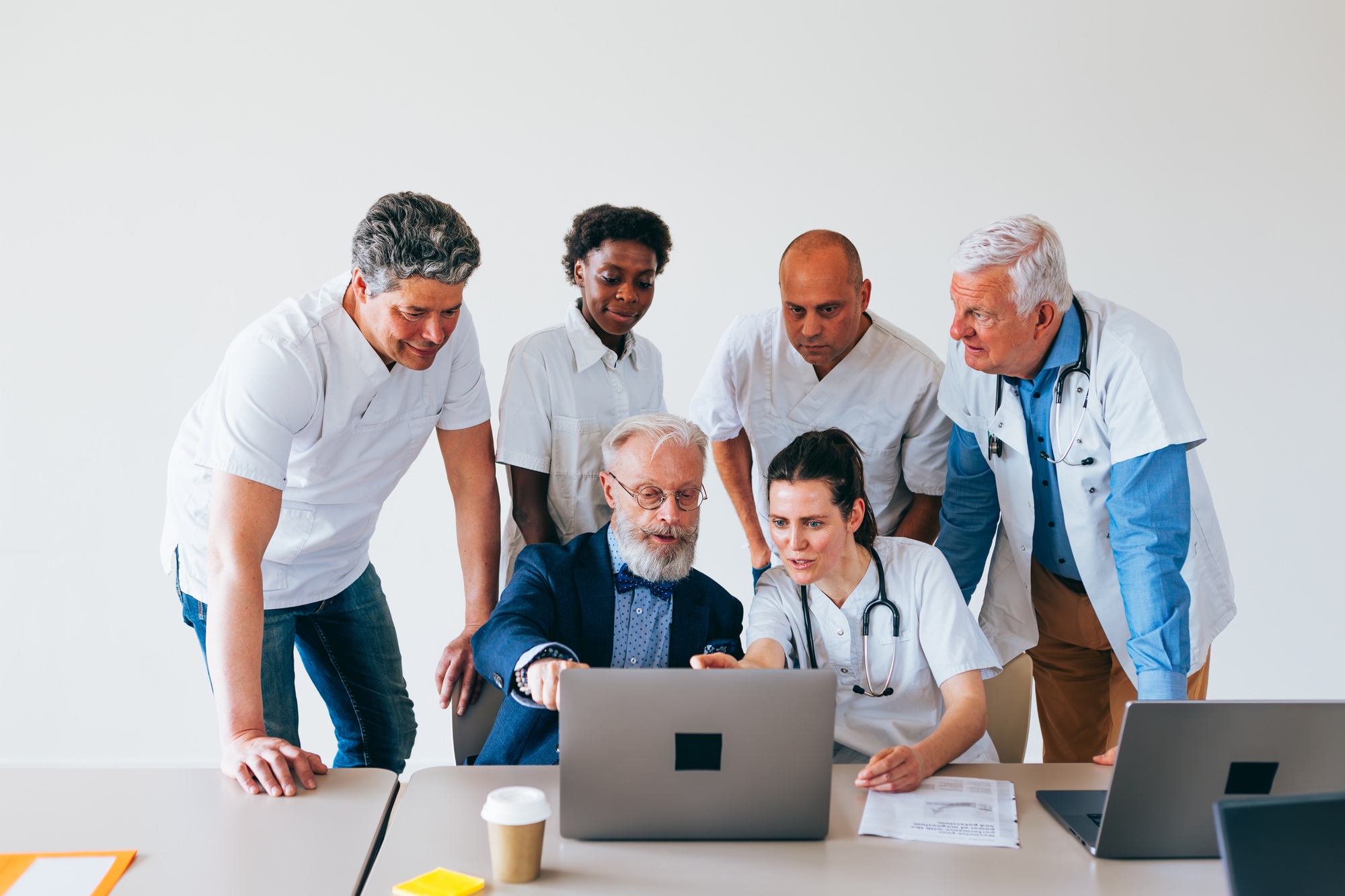 doctors studying medical case as team group in hospital room