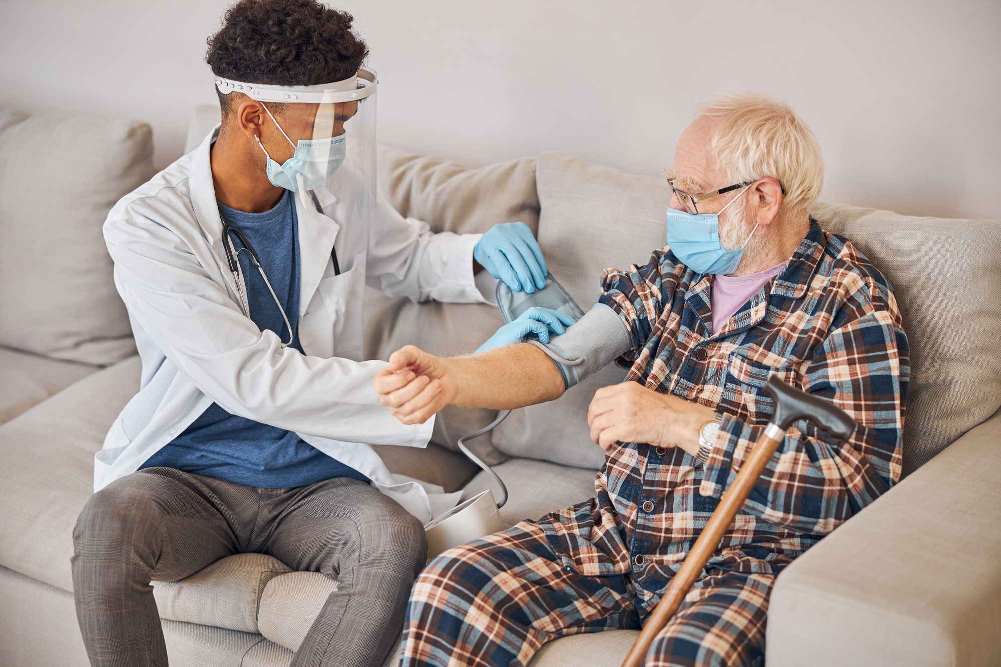 Geriatrician in a lab coat measuring the blood tension